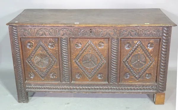 A 17th century oak coffer with triple carved panel front, 127cm wide x 69cm high x 58cm deep.Provenance; Property from Prudence and the late Marius Go