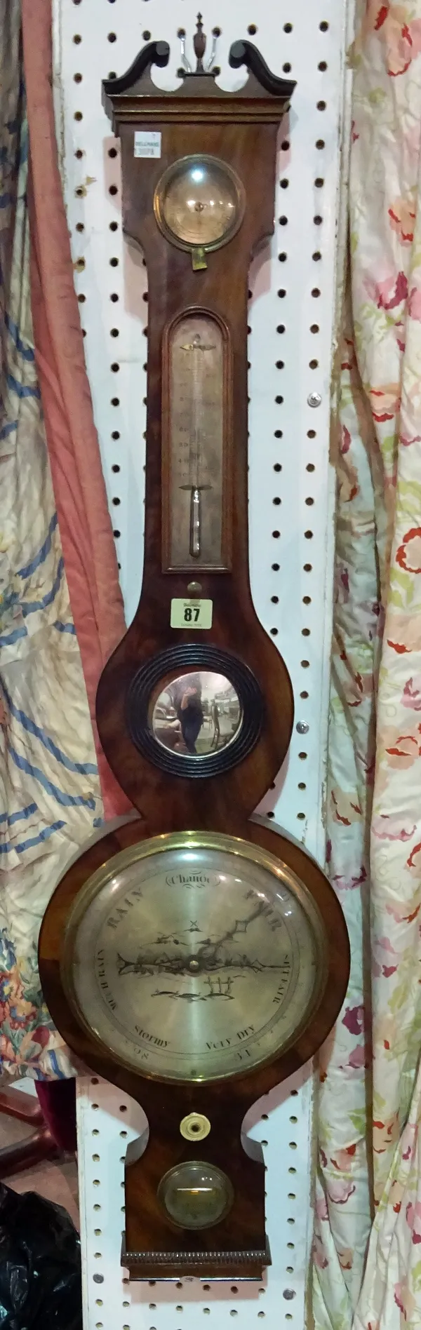 A George III mahogany wheel barometer by J & W LETTEY DUNSTER', broken arch pediment over thermometer and bullseye mirror with an 8 inch dial and leve