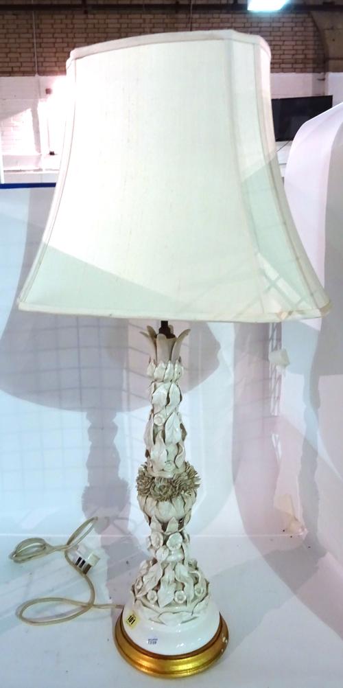 A 20th century porcelain lamp base moulded with flowers and leaves, 60cm high.   E7