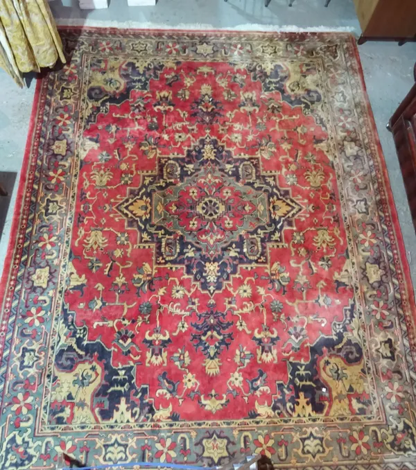 A machine made carpet of Persian design, 360 x 274cm.   J4
