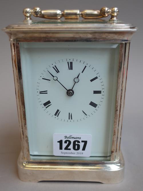 A French silver plated brass cased carriage clock, early 20th century, with white enamel dial, visible escapement and two train movement with hammer s