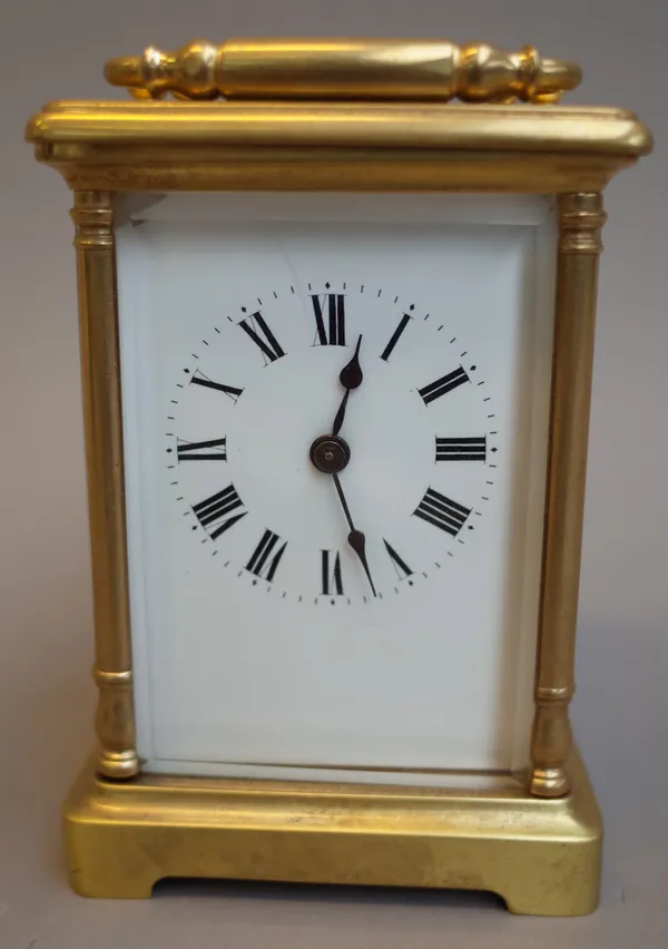 A brass cased carriage clock, 20th century, with visible escapement, white enamel dial and a single train movement, 11.5cm high with leather travel ca