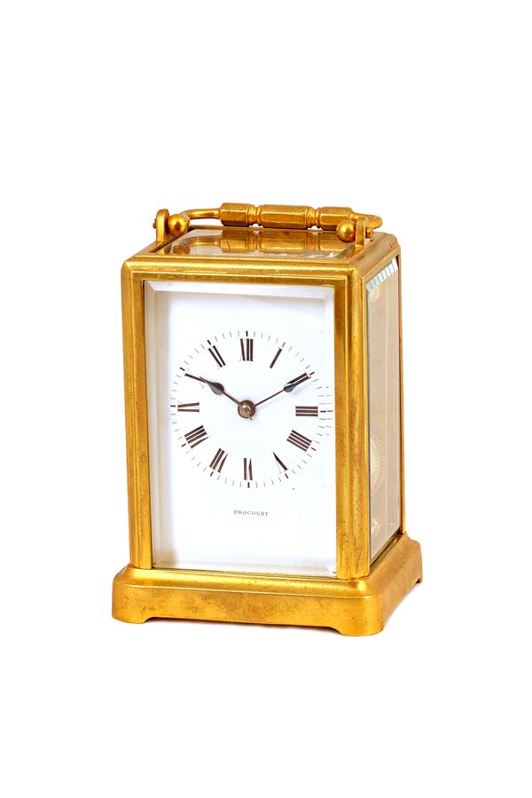 A French brass cased carriage clock, late 19th century, the white enamel dial detailed 'Drocourt', with visible escapement and hammer striking a bell,