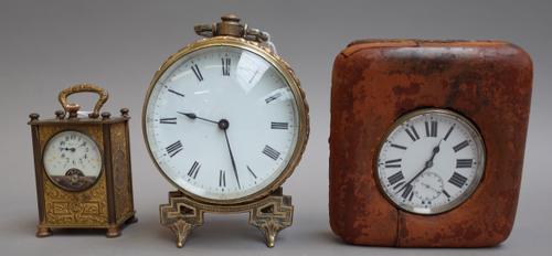 A white metal cased Goliath pocket watch with white enamel dial and subsidiary seconds hand, 7cm diameter, in a leather travel case, a gilt metal drum