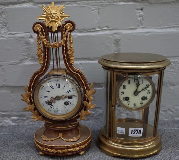 A gilt brass cased, oval four glass mantel clock with enamel dial and two train movement, 22cm high, (faux mercury movement) and a modern Marie Antoin