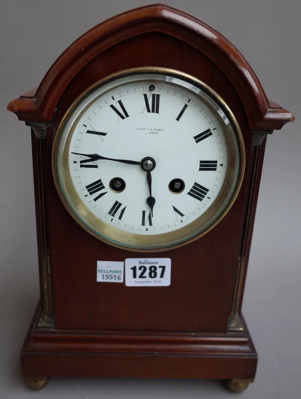 A French mahogany cased mantel clock, early 20th century, with arch top and white enamel dial detailed 'Mappin & Webb London' enclosing a two train mo