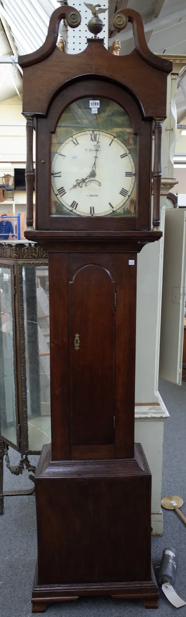 W.Barrow London; a 19th century oak longcase clock, with broken arch pediment and painted signed tin dial with crescent shaped date aperture over a wa