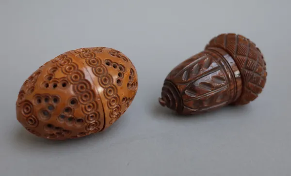 A carved coquilla nut nutmeg grater, early 19th century, of acorn form (7cm) and a fruitwood 'egg' shaped pomander with carved and pierced decoration