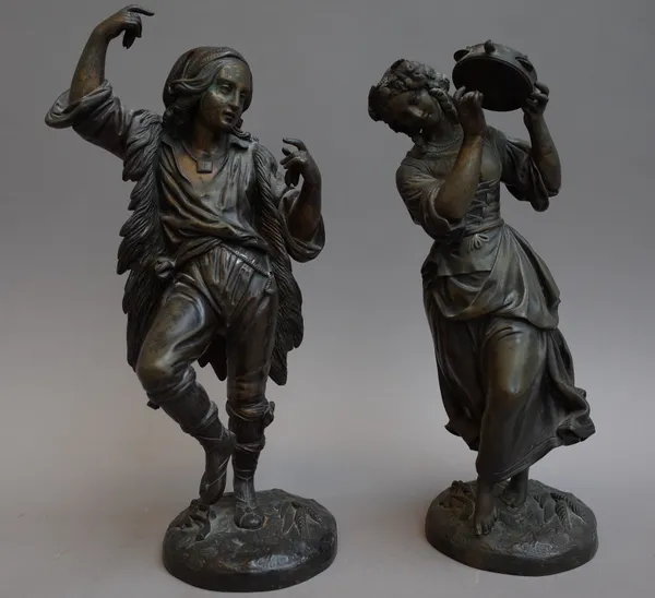 A pair of continental bronze figures, 19th century, cast as shepherd and shepherdess, both dancing, the lady playing a tambourine, each on a naturalis