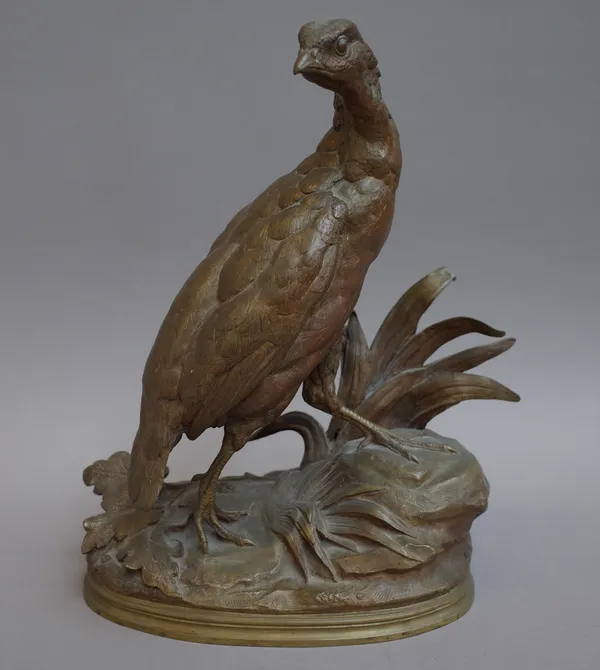 After Moigniez; a patinated French bronze model of a game bird, late 19th century, modelled atop a naturalistic base, signed to the cast 'Moigniez', 3