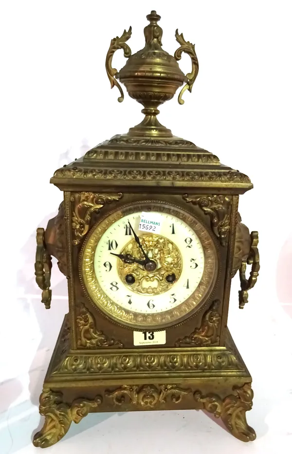 A late 19th century French 8 day metal cased clock, 40cm high with urn finial.   I4