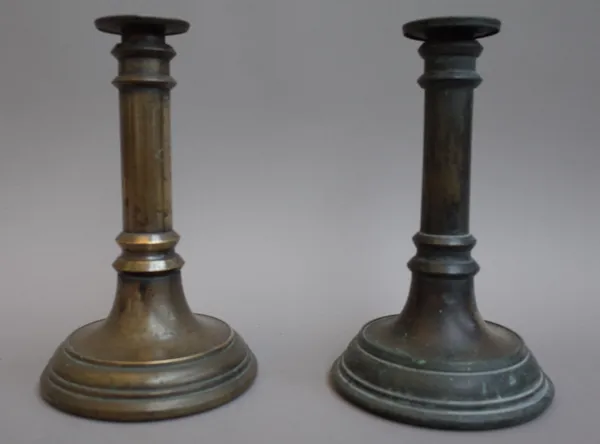 A matched pair of Victorian bronze candlesticks, each of turned form with 'V.R.' cypher, 22cm high (2)