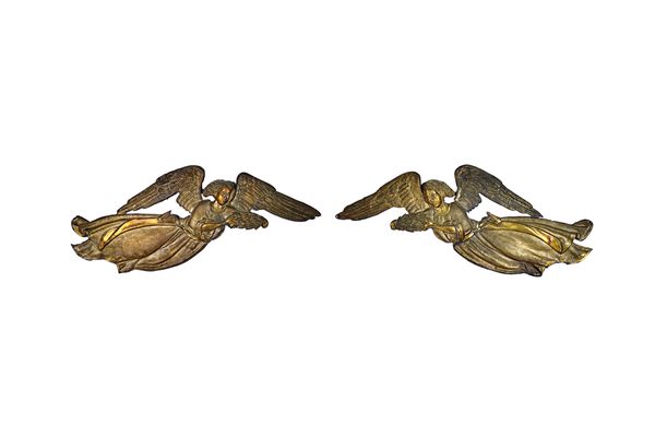 A pair of German repousse gilt metal 'angel' wall plaques, late 17th/early 18th century, each modelled holding a floral wreath, 70cm. (2). Provenance;