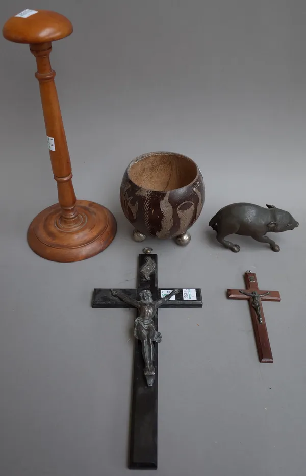 A small bronze model piglet, (3cm), a fruitwood wig stand (30cm high), a coconut carved bowl (lacking cover) and two white metal mounted crucifixes, (
