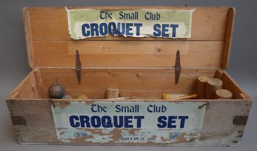 A Jaques vintage 'The Small Club' croquet set, comprising; four wooden mallets, four coloured balls, iron hoops and a centre stick in the original woo