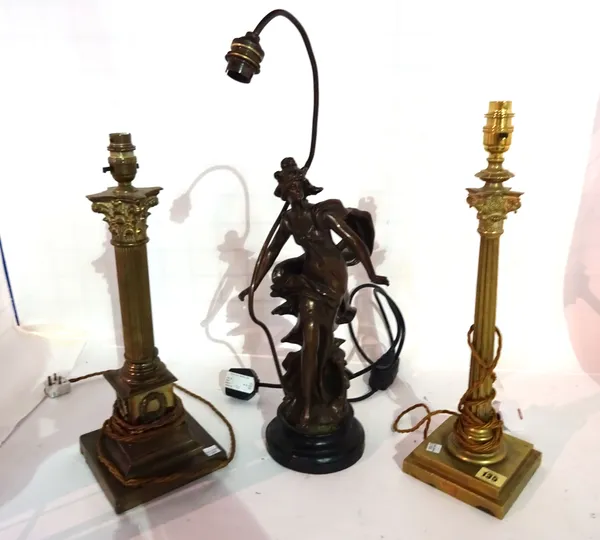 A gilt metal corinthium column shaped lamp, 40cm high another similar and a spelter figural lamp, (3).  S4M
