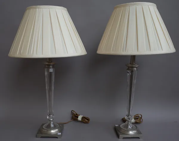 A pair of modern moulded glass and silver metal mounted table lamps with cream silk pleated shades, 71cm high. (2)