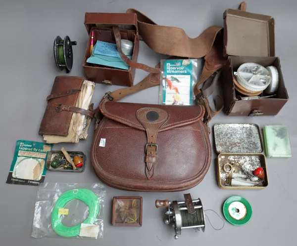 A quantity of fishing related items, including; a leather reel case, a canvas and leather bag, line, reels, fly tins, a leather pouch and sundry, also