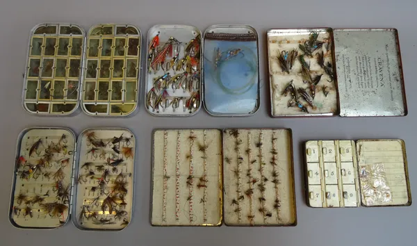 A quantity of fishing flies and vintage lines contained in alloy tins and a quantity of feathers and related line winding equipment contained in a Vic