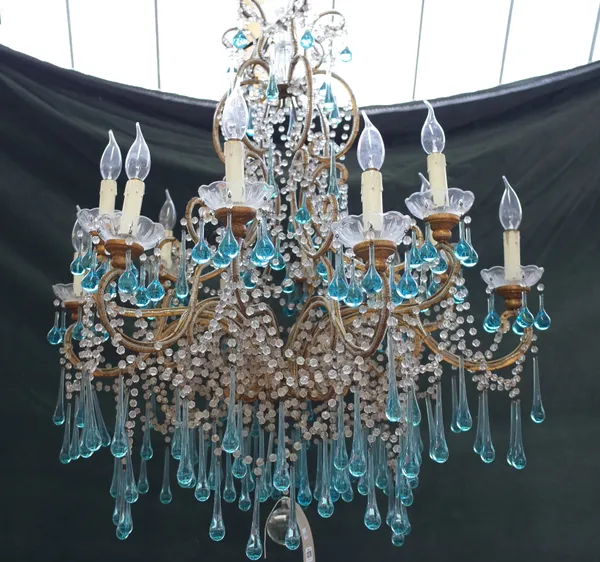 A Louis XV style gilt metal twelve branch chandelier, late 20th century, the scroll frame issuing twelve swan neck branches over two graduated tiers u