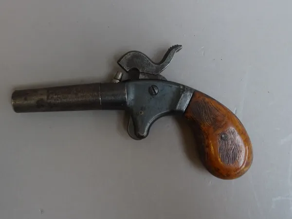 A 19th century percussion pocket pistol with twist off circular tapering steel barrel and two piece grip, 14cm overall.