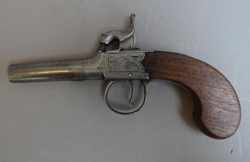 A 19th century boxlock percussion pistol with twist off circular tapering steel barrel, foliate engraved lockplate and one piece wooden grip, 17cm ove