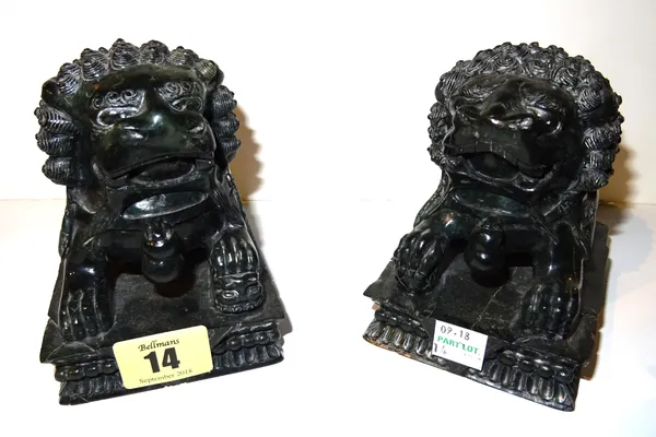 A pair of Chinese green hardstone carved dogs of Fo, each on a rectangular plinth, 11.5cm wide, (2).  CAB