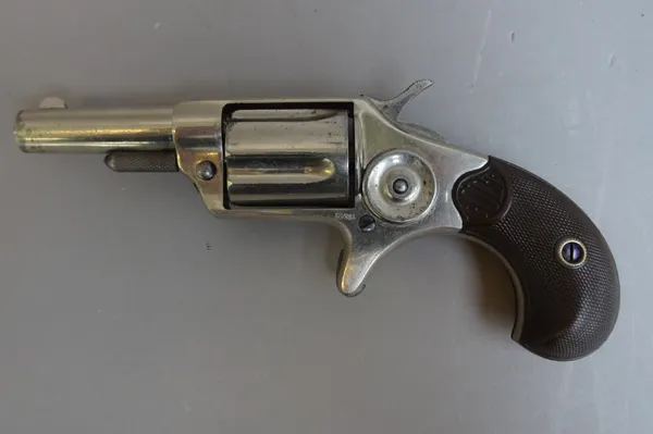 A Colt New Line, .32 calibre, five shot, rim fire revolver, circa 1884, nickel finish, circular barrel, plain body and finely chequered composite grip