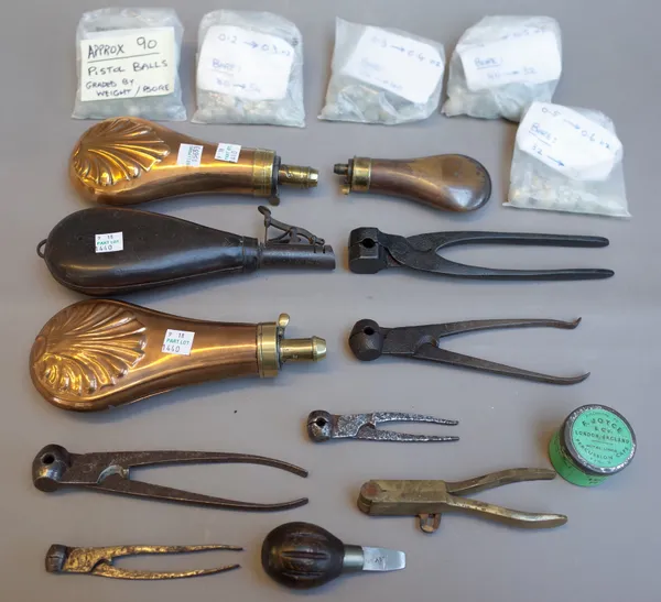 A collection of firearm accoutrements, including; pistol balls and bullets, four powder flasks, eight ball moulds and tools, (qty)