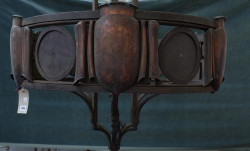 A steel, copper mounted chandelier, early 20th century, of circular form, the plates of scroll form, interspersed with Tudric roses, formerly with han