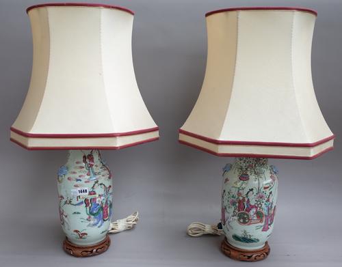 A pair of Chinese Canton porcelain vase table lamps, 19th century each with twin dog of fo handles decorated with figures and animals against a landsc