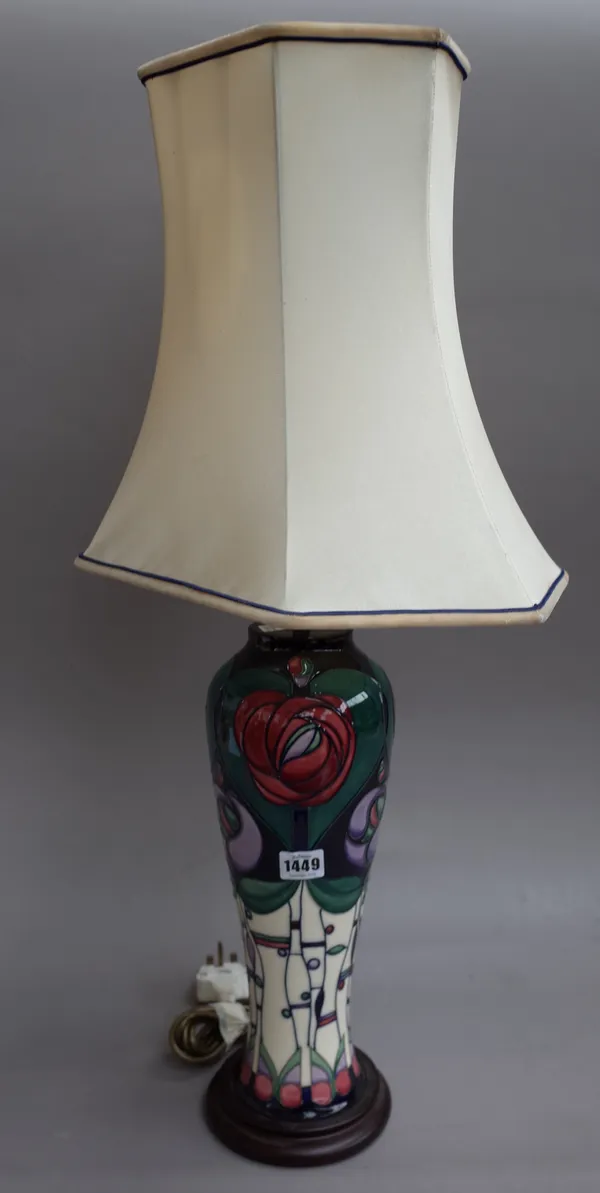 A Moorcroft style pottery table lamp of foliate Arts & Crafts design on a wooden plinth with shaped shade, 38cm high excluding fitments.