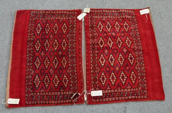 A pair of Yomut Chuvals, the madder field with four rows of four guls, supporting diamonds; a pale indigo cross border, 107cm x 78cm, (2).