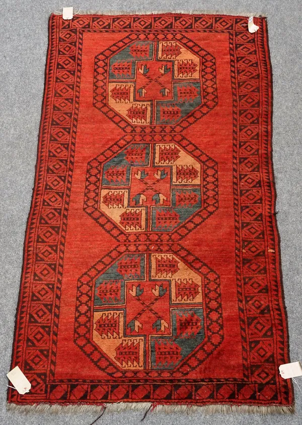 An Afghan Ersari rug, the madder field with three bold single medallions, a diamond border, 200cm x 117cm.