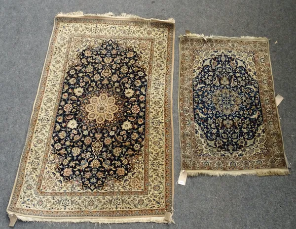 A Nain part silk rug, Persian, the dark indigo floral field with a central medallion and matching spandrels on ivory palmette border, 126 x  79cm and