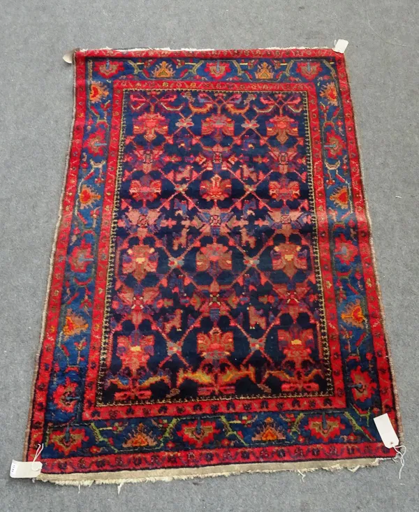 A Mahal rug, Persian, the indigo field with a trellis design, indigo border of palmettes and vine, 130 x 205cm.