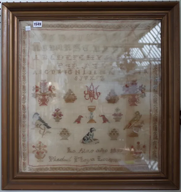 A woodwork alphabet sampler dated 1897, indistinctly signed, with alphabet over flora and fauna in a giltwood frame, 51cm x 55cm.