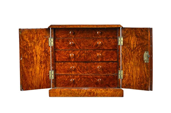 A Victorian figured walnut table top collector's chest, the pair of shaped doors enclosing five drawers on plinth base, 40cm wide x 40cm high x 23cm d