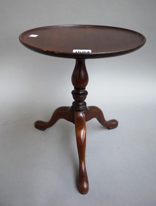 A diminutive mahogany tripod table with circular dish top and baluster column, 28cm diameter x 34cm high.