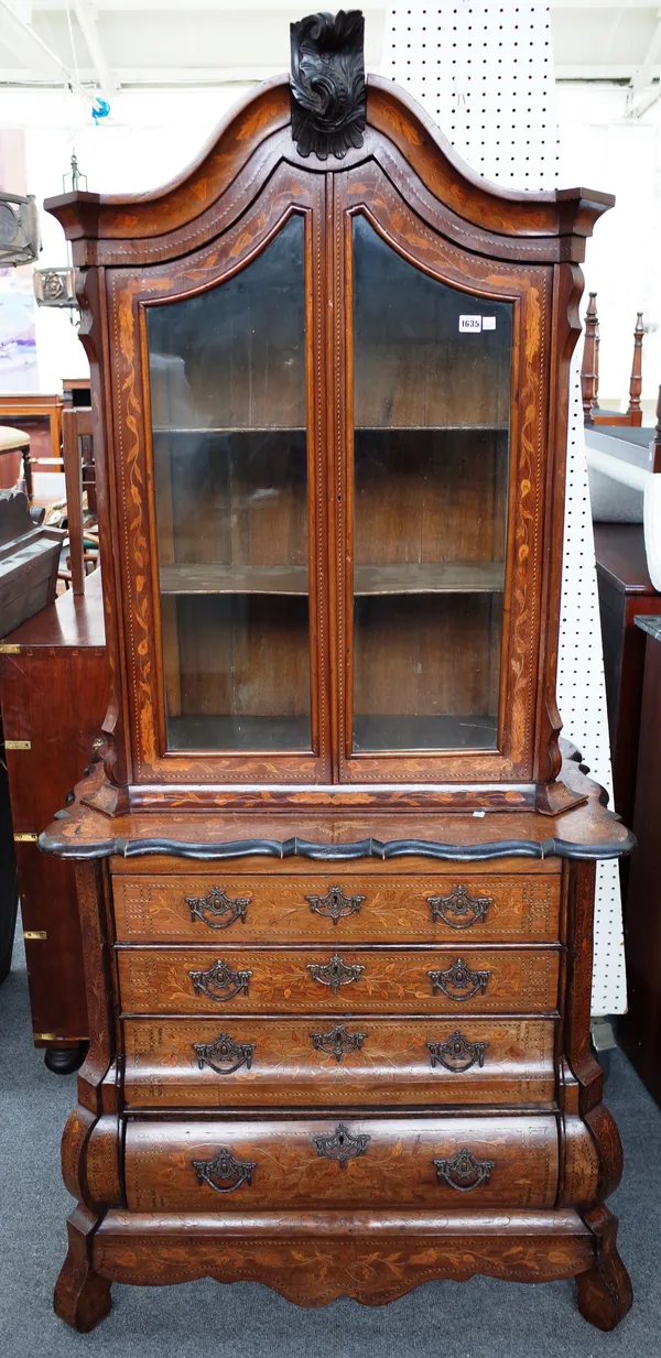 A 19th century Dutch floral marquetry inlaid display cabinet chest, the pair of glazed doors over a bombe four drawer base, 95cm wide x 194cm high x 5