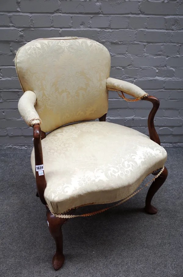 A mid-18th century mahogany framed open armchair, with serpentine seat and cabriole supports, 67cm wide x 88cm high.