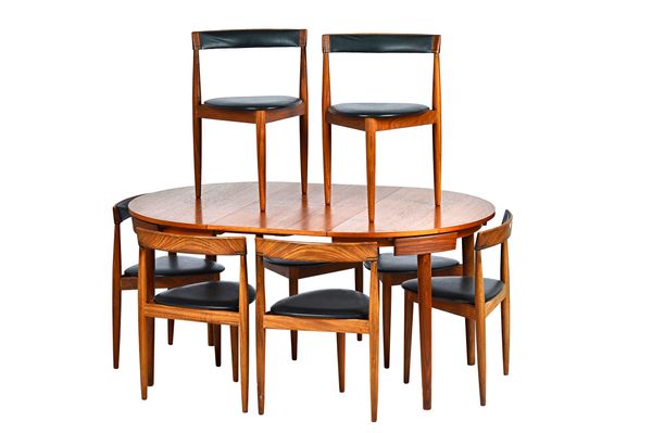 HANS OLSEN FOR FREM ROJLE; a 1960s teak circular extending dining table on tapering turned supports, 106cm diameter x 156cm long extended, together wi