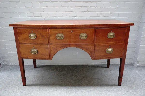 A George III mahogany bowfront sideboard with five frieze drawers on tapering square supports, 145cm wide x 86cm high x 68cm deep.