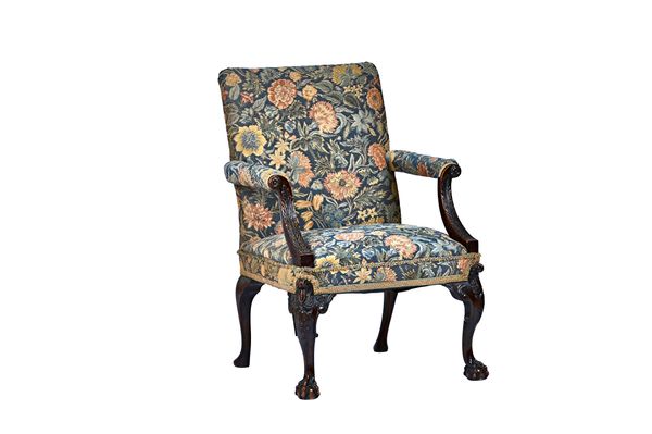 A mid-19th century mahogany framed Gainsborough chair, of George III style, with carved downswept open arms and ball and claw feet, 72cm wide x 107cm