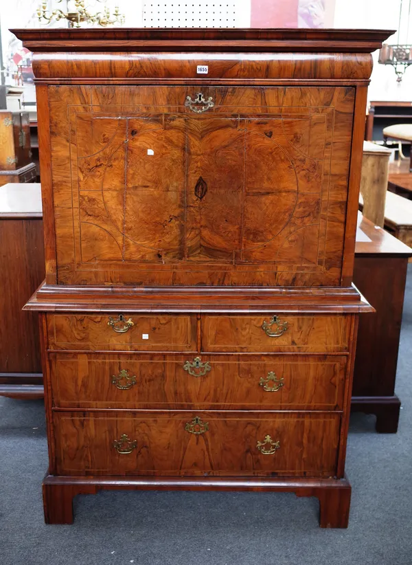A William and Mary figured walnut secretaire chest, with flush fit upper drawer over full front (interior lacking) with two short and two long graduat