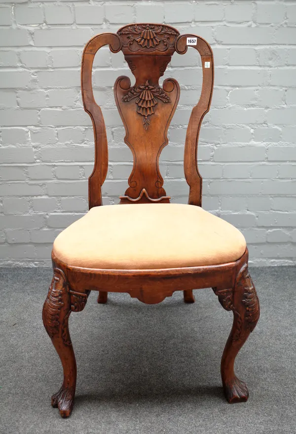 A George I provincial oak framed vase back dining chair, with bow seat and leaf carved cabriole supports, 55cm wide x 103cm high.