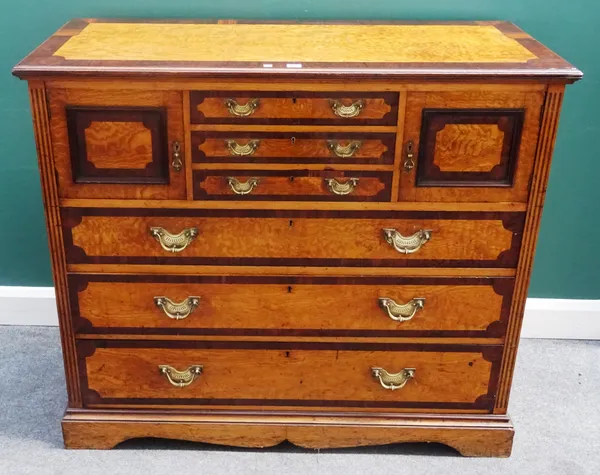A Victorian rosewood banded figured ash chest, with three short drawers flanked by cupboards, over three further long graduated drawers, on bracket fe