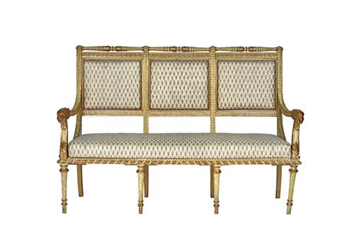 A French 18th century style parcel gilt cream painted open arm sofa, with eagle head finials, on spiral fluted supports, 154cm wide x 106cm high. Illu