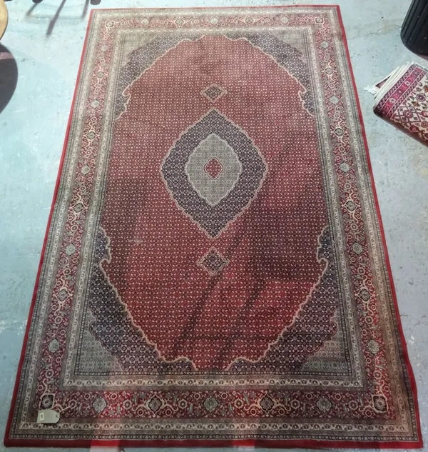 A 20th century red Turkish rug, 195cm wide x 296cm high.  BAY 3