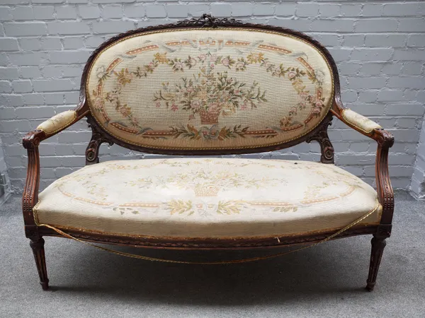 A Louis XVI style carved and stained beech salon suite comprising; a sofa, 140cm wide x 107cm high, three armchairs 63cm wide x 101cm high and two sid